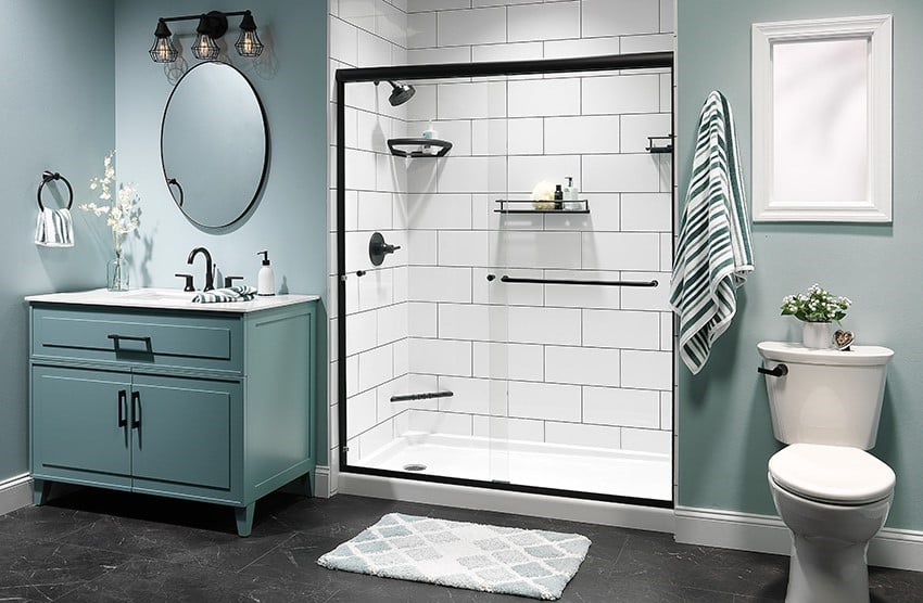 A bathroom featuring blue walls and white tile, creating a clean and modern aesthetic.