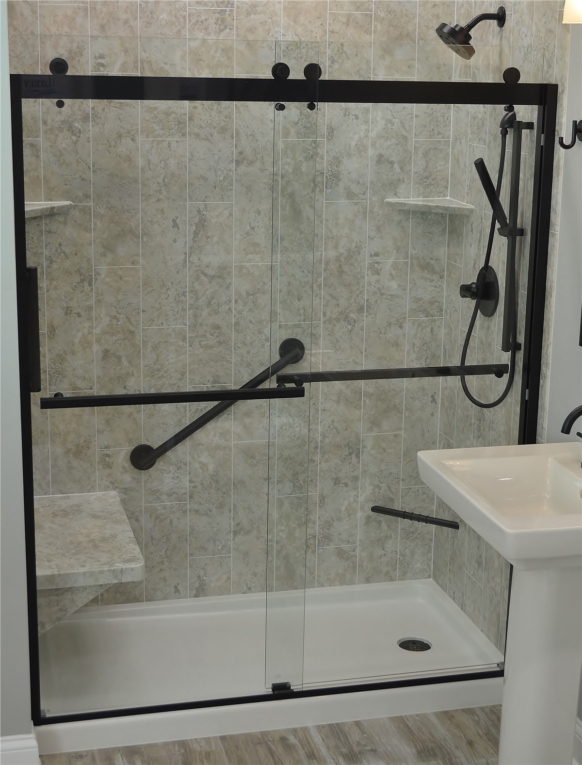 A modern bathroom featuring a glass shower door and a sleek sink.