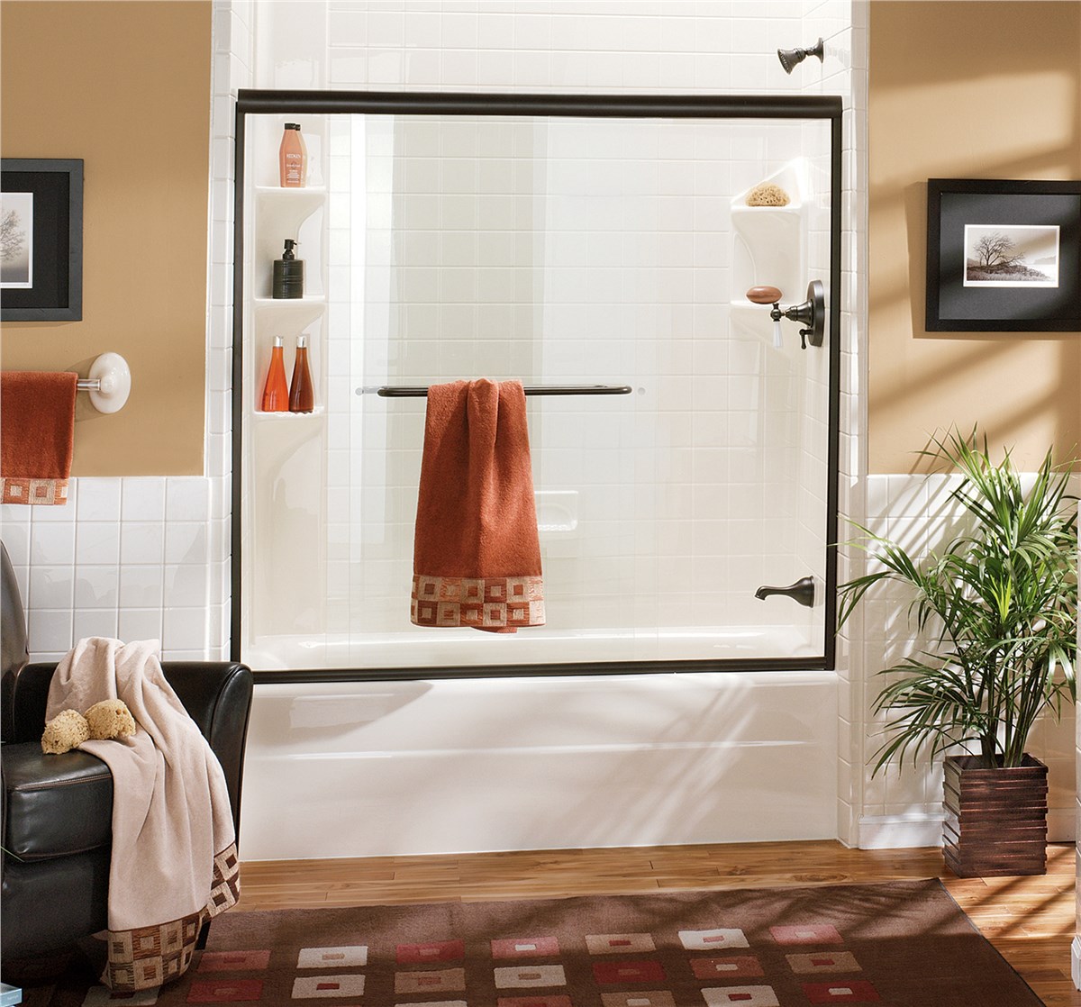 A clean bathroom featuring a shower, toilet, and sink, with neutral-colored tiles and modern fixtures.