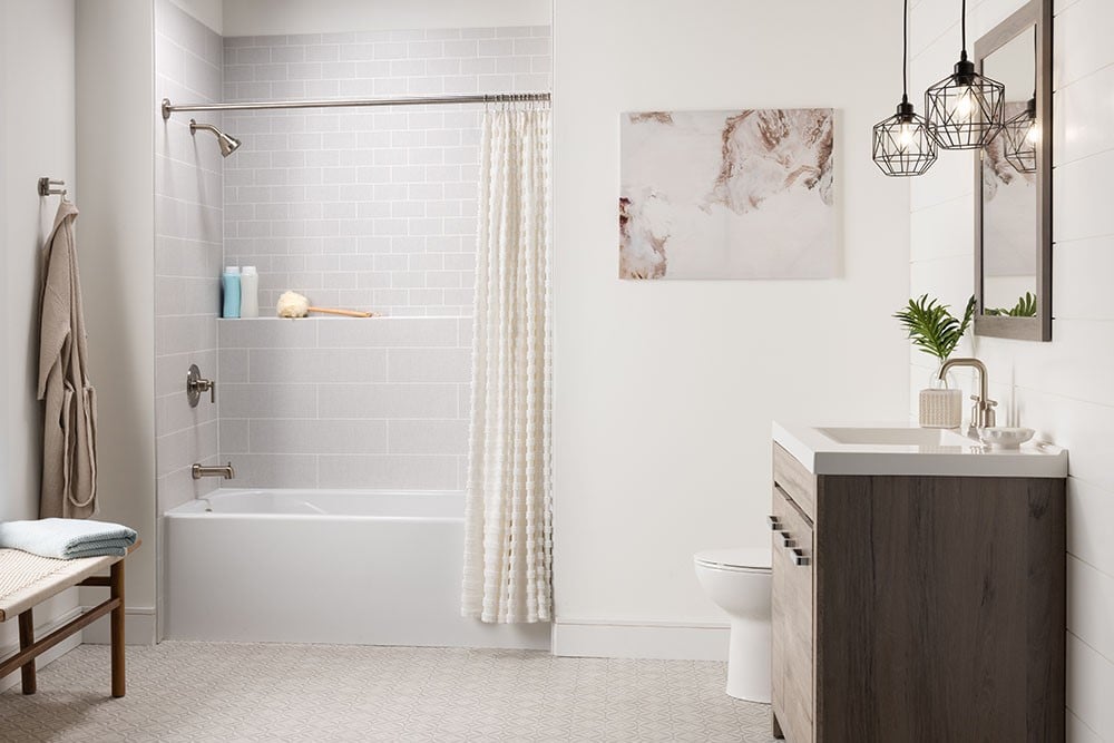 A bathroom featuring a shower, toilet, sink, and bathtub, designed for functionality and comfort.